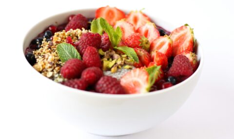 Colorful bowl of fresh strawberries and mixed berries, rich in natural antioxidants that help fight free radicals and support overall wellness.