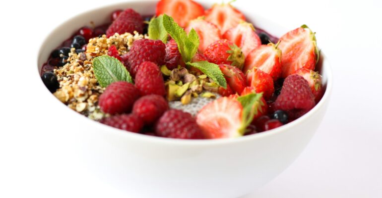 Colorful bowl of fresh strawberries and mixed berries, rich in natural antioxidants that help fight free radicals and support overall wellness.